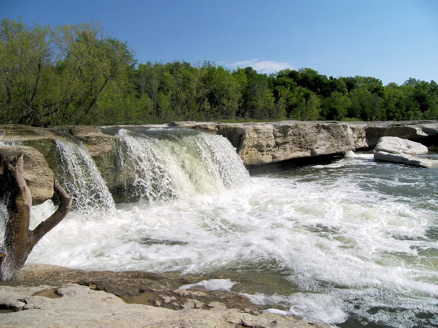 Water pouring over the limestone lower falls at McKinney Falls State Park